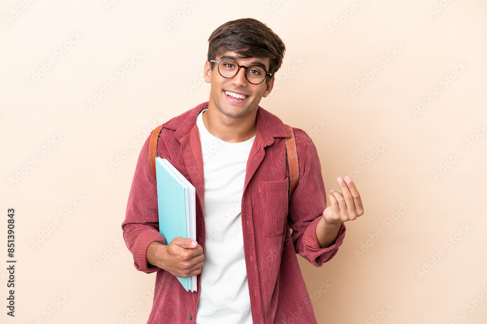 Young student caucasian man isolated on ocher background making money gesture