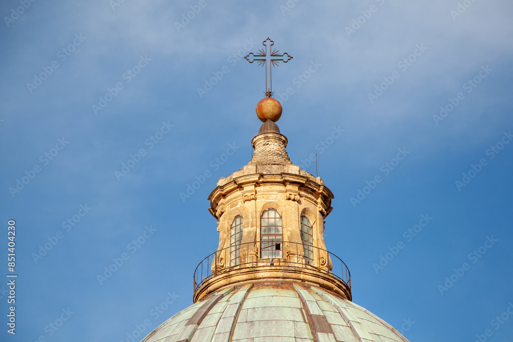 The skyward view of Palermo Cathedral dome, crowned with a cross, reflects the grandeur of this historical and religious symbol The skyward view of Palermo Cathedral dome, crowned with a cross, reflects the grandeur of this historical and religious symbol