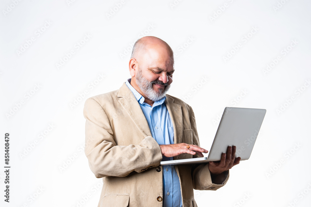 portrait of senior old Indian asian businessman using laptop against white background portrait of senior old Indian asian businessman using laptop against white background