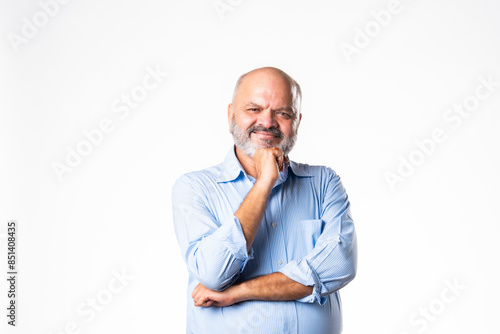 Cheerful senior Indian asian old age senior man looking at camera against white