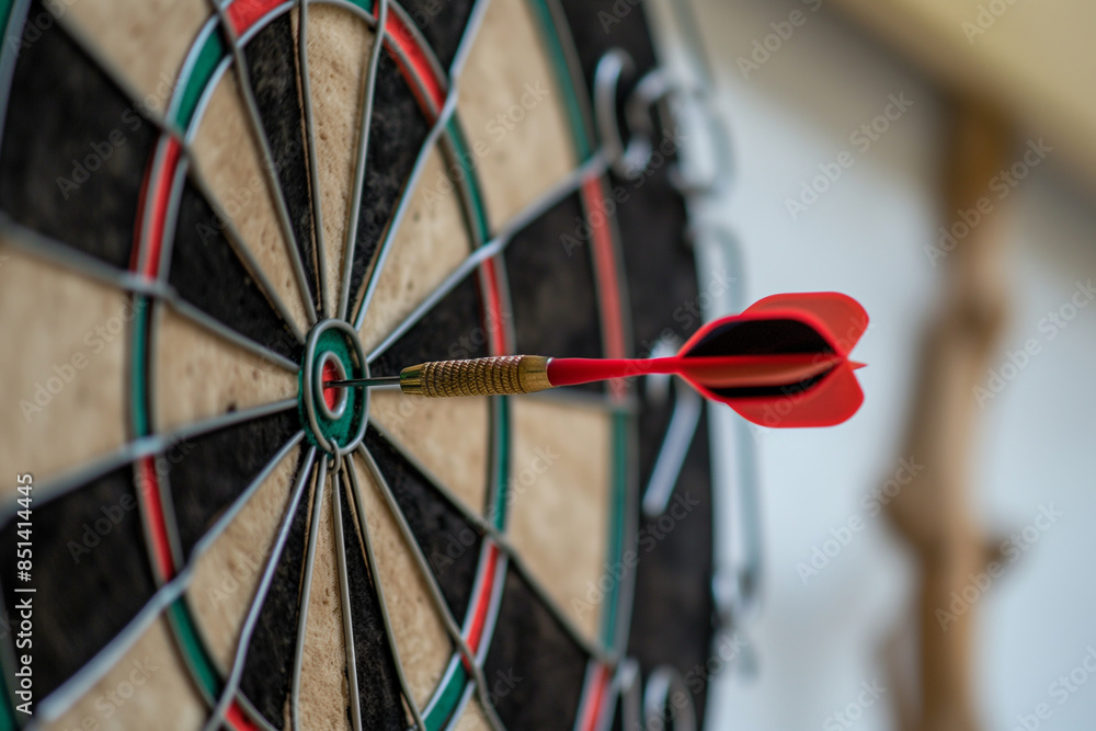 Red arrow in the middle of the dartboard Ideas are business goals. Darts are opportunities. Setting goals and achieving business goals. Red arrow in the middle of the dartboard Ideas are business goals. Darts are opportunities. Setting goals and achieving business goals.