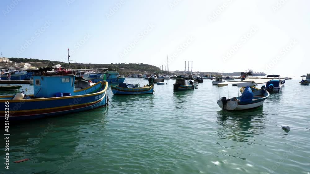 Marsaxlokk harbour with Traditional Luzzu fishing boats, a beautiful Mediterranean town on a sunny day. Old Colorful Boats. Malta Marsaxlokk harbour with Traditional Luzzu fishing boats, a beautiful Mediterranean town on a sunny day. Old Colorful Boats. Malta