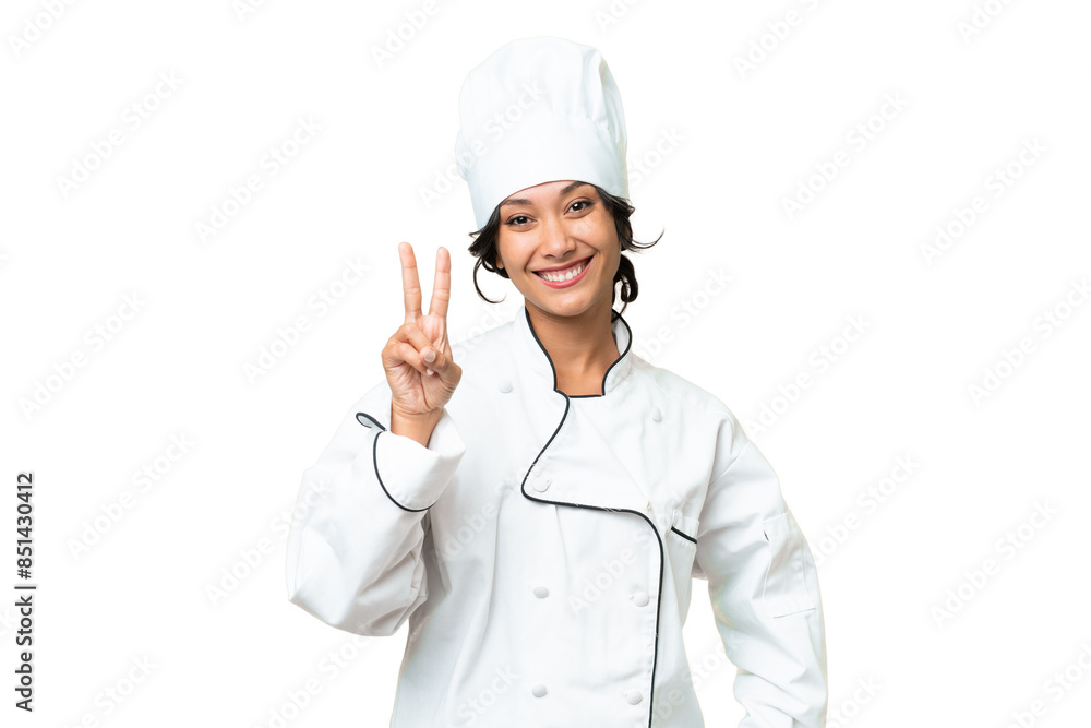 Young chef Argentinian woman over isolated background smiling and showing victory sign Young chef Argentinian woman over isolated background smiling and showing victory sign