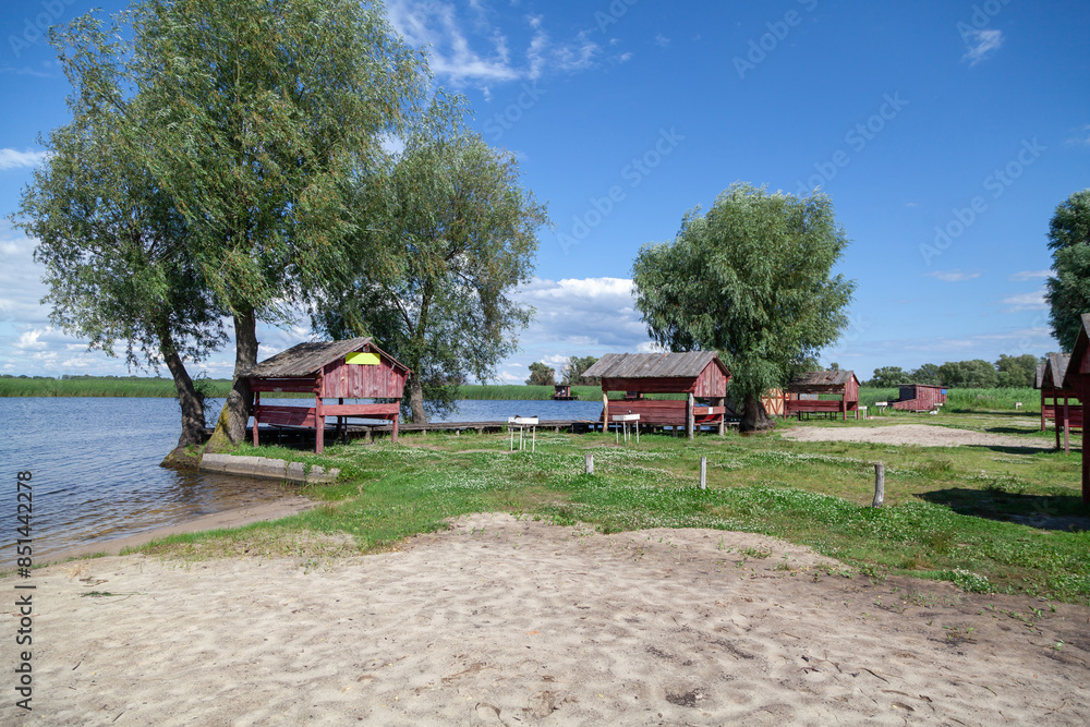 There are wooden gazebos on river bank There are wooden gazebos on river bank