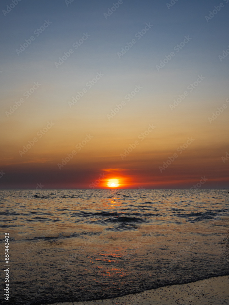 Obraz premium Sunset sea vertical view landscape horizon beautiful summer season shore nobody wind wave cool holiday look calm big sunset sky twilight evening day time nature tropical coast ocean water travel