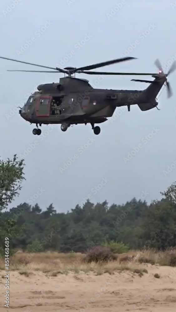 Military Helicopter Hovering between trees low altitude Military Helicopter Hovering between trees low altitude