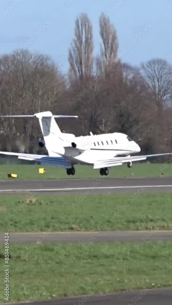 Business jet Landing with Touch Down at Airport (Corporate Executive Private Jet Touching down at Airfield) Business jet Landing with Touch Down at Airport (Corporate Executive Private Jet Touching down at Airfield)
