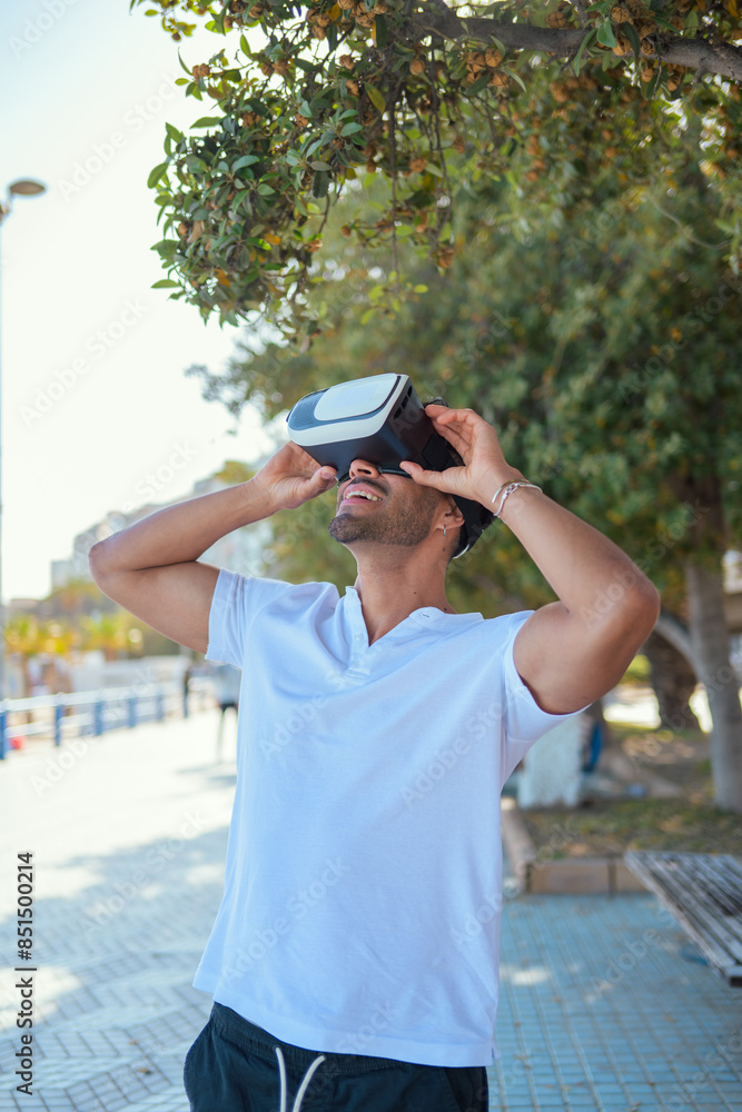 Fototapeta premium Man experiencing virtual reality on a sunny day in the city