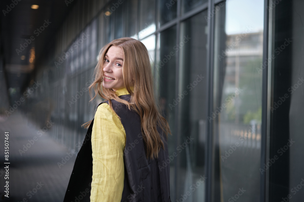 Beautiful blond female office worker on the background of office building . Positive emotions, wearing yellow shirt and jacket. High quality photo Beautiful blond female office worker on the background of office building . Positive emotions, wearing yellow shirt and jacket. High quality photo