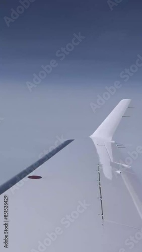 Airplane Wing view Outside clouds sky business jet aircraft photo