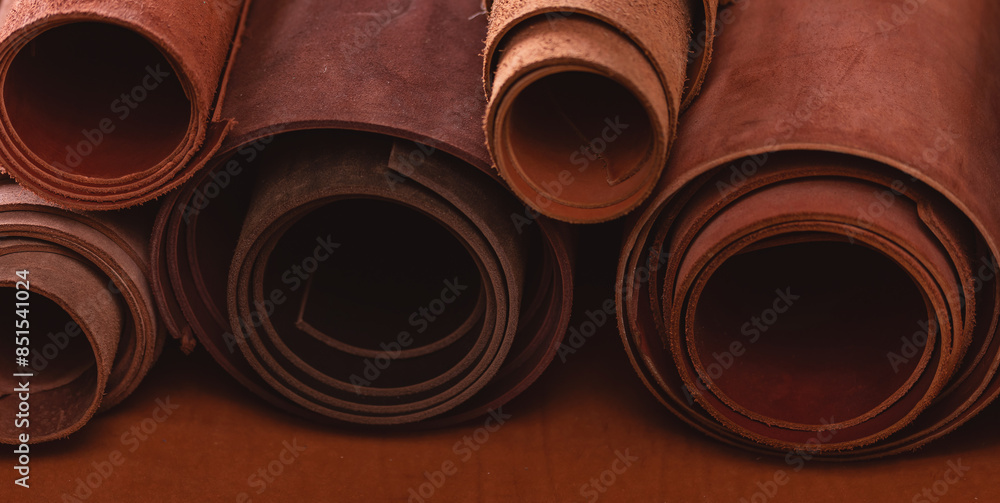 Brown rolled leather in shoemaker workshop, background tailor footwear industry Brown rolled leather in shoemaker workshop, background tailor footwear industry