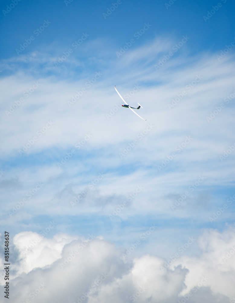 a sailplane in the air above the clouds a sailplane in the air above the clouds