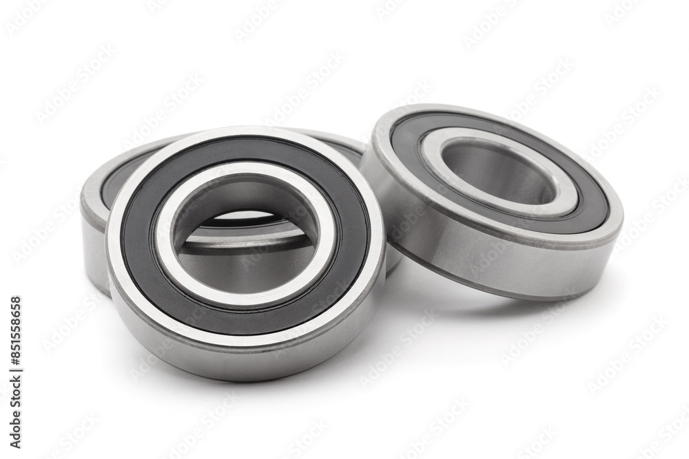 A collection of assorted tapered roller bearings of various sizes, isolated on a white background. A collection of assorted tapered roller bearings of various sizes, isolated on a white background.