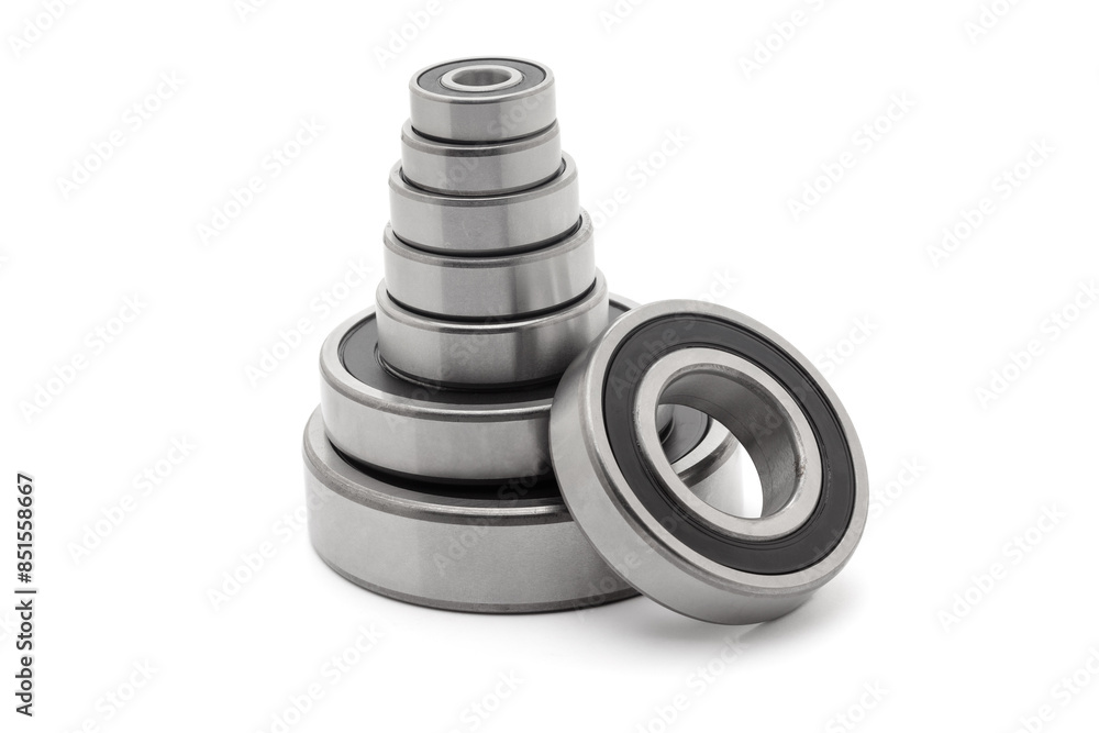 A collection of assorted tapered roller bearings of various sizes, isolated on a white background. A collection of assorted tapered roller bearings of various sizes, isolated on a white background.