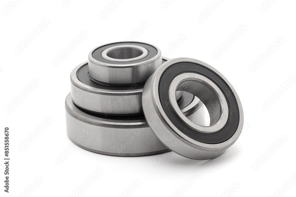 A collection of assorted tapered roller bearings of various sizes, isolated on a white background. A collection of assorted tapered roller bearings of various sizes, isolated on a white background.