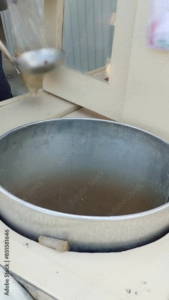 A mobile seller of green bean porridge is serving his customers in the morning A mobile seller of green bean porridge is serving his customers in the morning