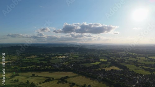 Aerial view of beautiful british countryside with sun shining over farmland photo