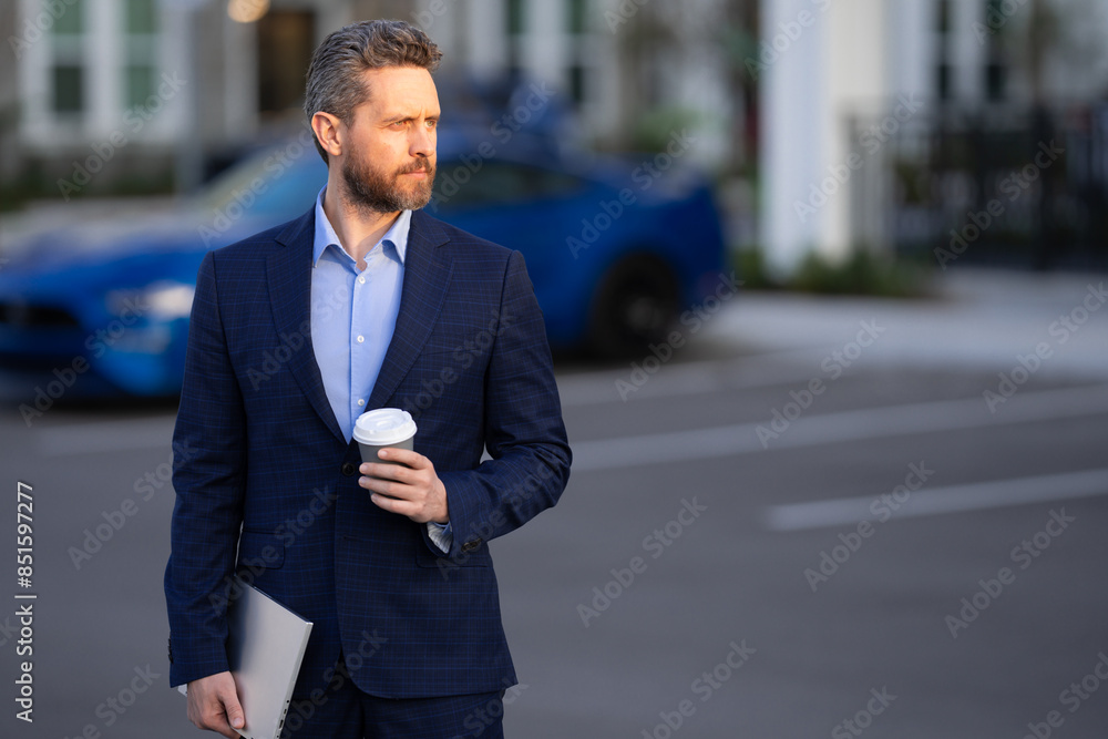 Outside portrait of man in suit. Businessman walking in city. Hispanic man walk on street. Business man with laptop and coffee walking outdoor. Businessman in suit go to office work. Success man. Outside portrait of man in suit. Businessman walking in city. Hispanic man walk on street. Business man with laptop and coffee walking outdoor. Businessman in suit go to office work. Success man.