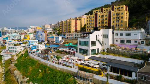 aerial view of Huinnyeoul Culture Village in Busan, Korea. The picture showcases a coastal village with a terraced landscape, colorful buildings, and a beautiful seafront. photo