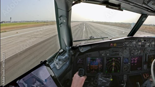 take off or takeoff seen forward view from cockpit of aircraft, airplane, jet plane from holiday destination, travel spot coast line with beach and many instruments and controls on the flight deck