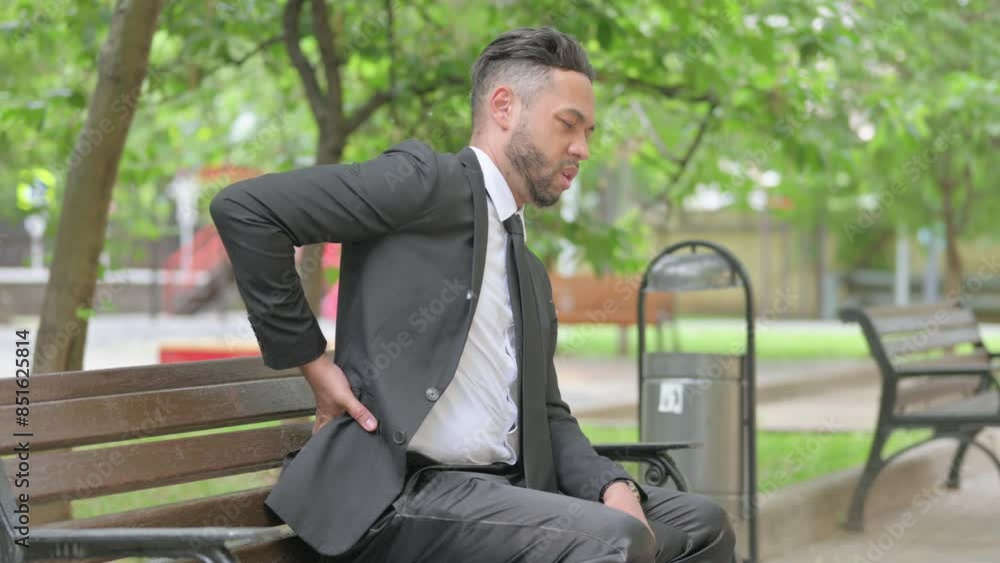 Mixed Race Businessman with Spinal Injury having Back Pain Outdoor Mixed Race Businessman with Spinal Injury having Back Pain Outdoor