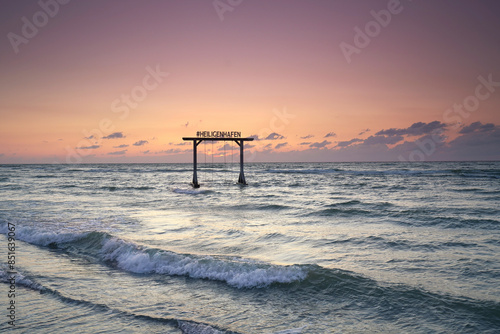 Fototapeta Naklejka Na Ścianę i Meble -  a wooden swing on the beach of Heiligenhafen on Baltic Sea