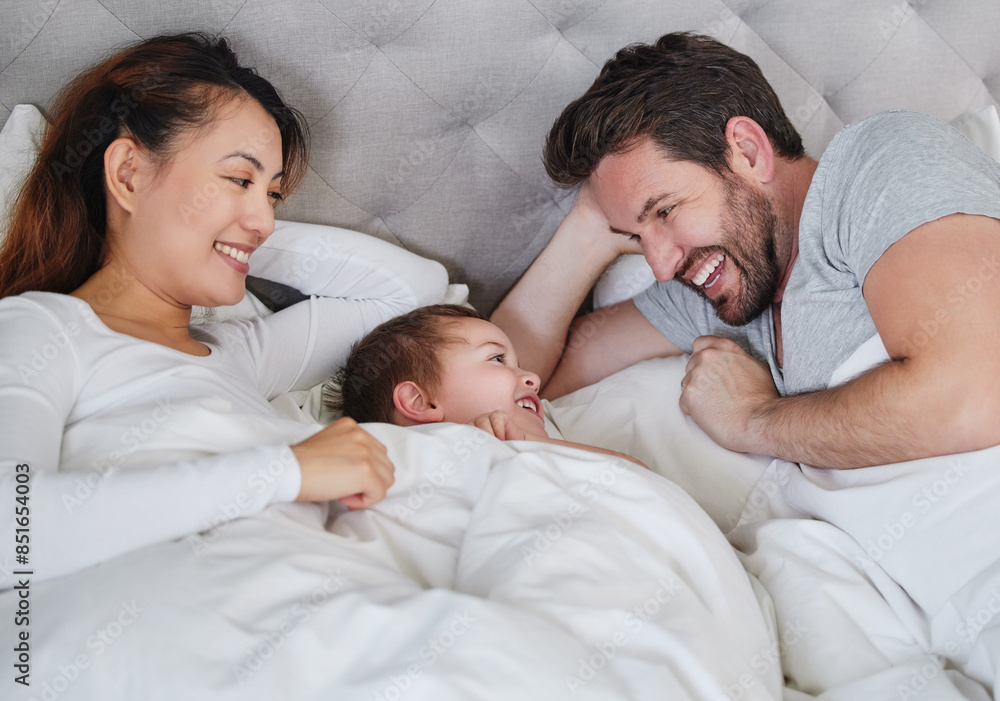 Mother, son and father in bedroom, smile and bonding with love, man and woman with care for boy in home. Mom, dad and kid together on bed, happiness and relax in weekend, parents and child in house Mother, son and father in bedroom, smile and bonding with love, man and woman with care for boy in home. Mom, dad and kid together on bed, happiness and relax in weekend, parents and child in house