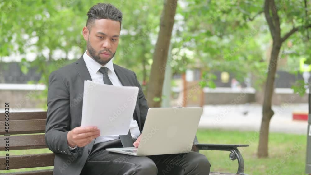 Mixed Race Businessman Working on Documents and Laptop Outdoor Mixed Race Businessman Working on Documents and Laptop Outdoor