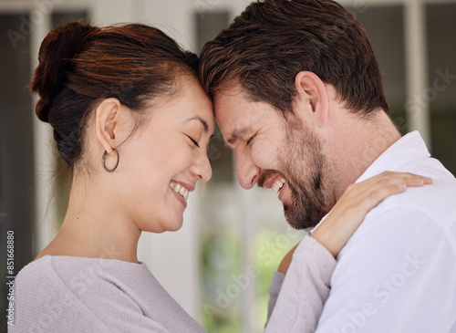 Home, forehead and couple with love, smile and bonding together with happiness, romance or cheerful. People, man and woman with care, marriage or relationship with affection, trust and peace with joy © peopleimages.com