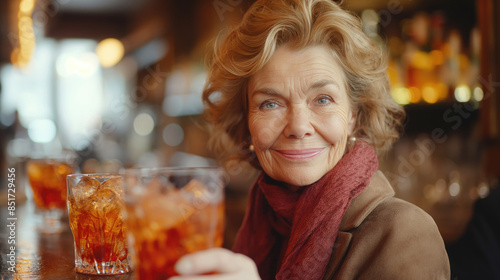 Smiling Elderly Woman Enjoying a Drink in a Cozy Bar Setting.