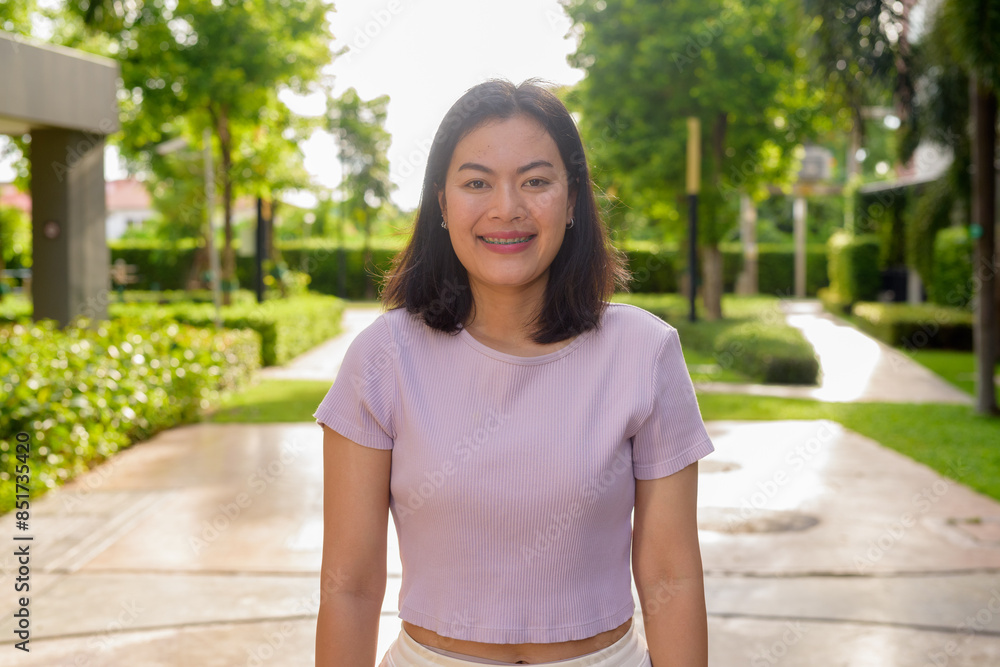 Naklejka premium Portrait of beautiful Asian woman outdoor in park during summer