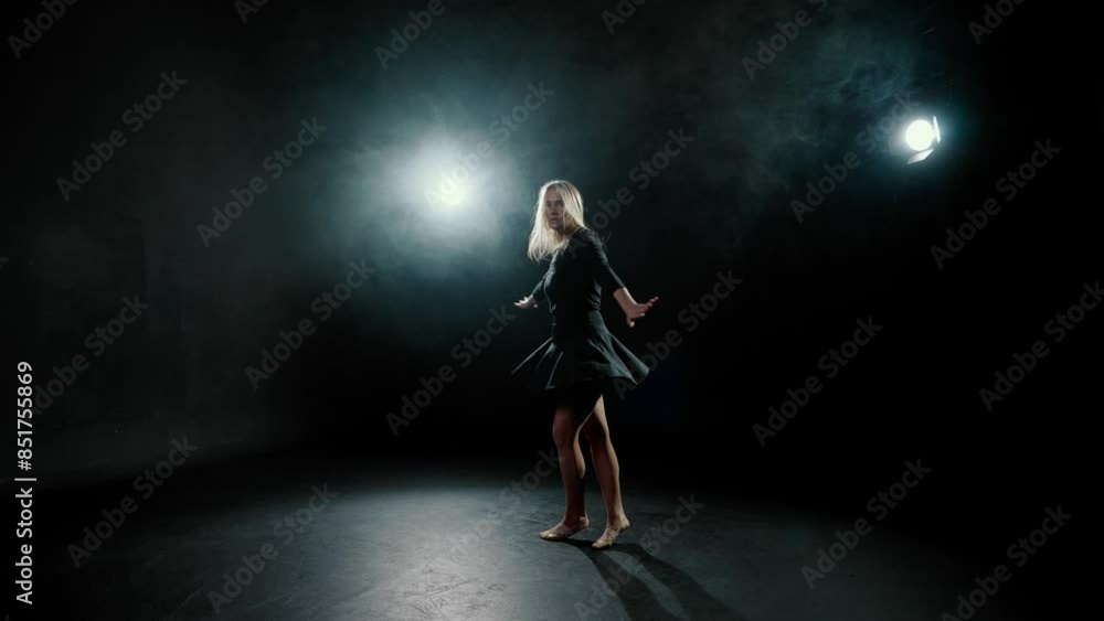 Modern ballerina dancing in darkness, graceful lady jumping, slow motion. Talented female dancer rehearsing contemporary choreography in dark dance class, silhouette of pretty slender lady in black Modern ballerina dancing in darkness, graceful lady jumping, slow motion. Talented female dancer rehearsing contemporary choreography in dark dance class, silhouette of pretty slender lady in black