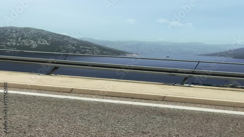 The car is driving along a beautiful landscape mountain road in Montenegro. First-person view. POV Point of view of a driver driving along a picturesque and empty road towards the mountains, photo