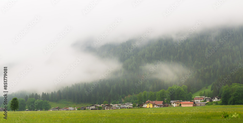 Misty Mountain Village in Alpine Valley, with serene nature and landscape Misty Mountain Village in Alpine Valley, with serene nature and landscape