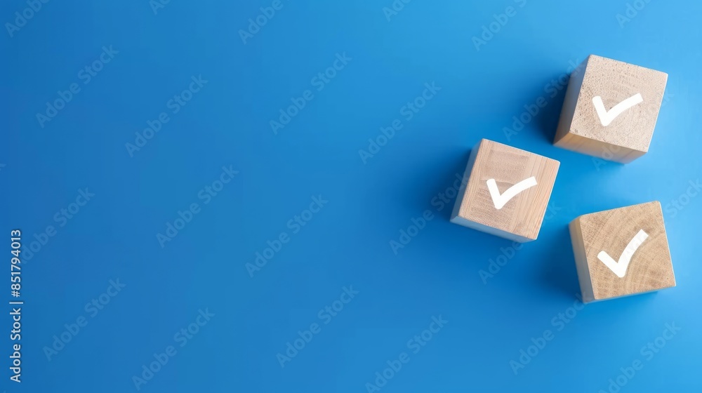 Three wooden cubes with check mark icons on a blue background Three wooden cubes with check mark icons on a blue background