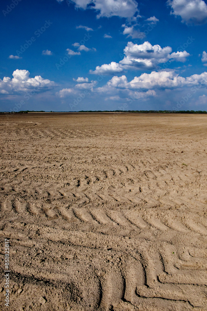 Cloudy sky over an expansive, freshly ploughed field. Cloudy sky over an expansive, freshly ploughed field.
