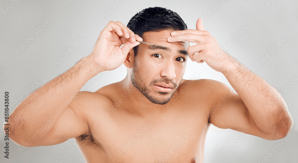 Man, tweezers and eyebrow in studio portrait, grooming and plucking for epilation on white background. Male person, skincare and maintenance for hygiene routine or clean, beauty and facial cosmetics Man, tweezers and eyebrow in studio portrait, grooming and plucking for epilation on white background. Male person, skincare and maintenance for hygiene routine or clean, beauty and facial cosmetics