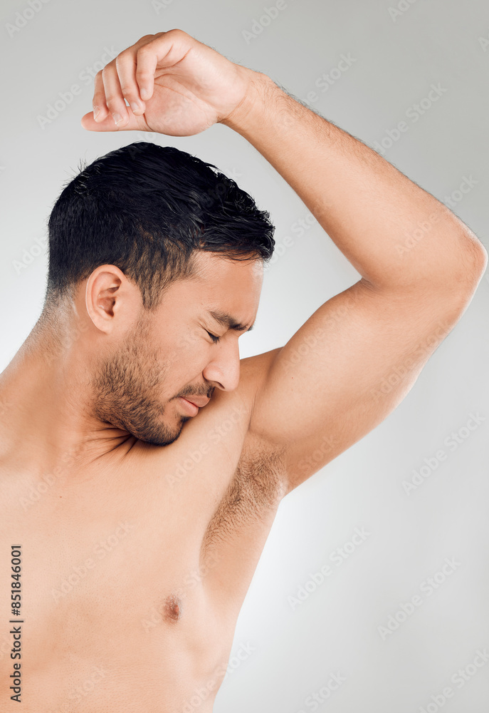 Grooming, man and armpit with bad smell in studio for routine, wellness and skincare for hygiene on white background. Male person, underarm and stink of sweat or body odor for fragrance or cologne Grooming, man and armpit with bad smell in studio for routine, wellness and skincare for hygiene on white background. Male person, underarm and stink of sweat or body odor for fragrance or cologne