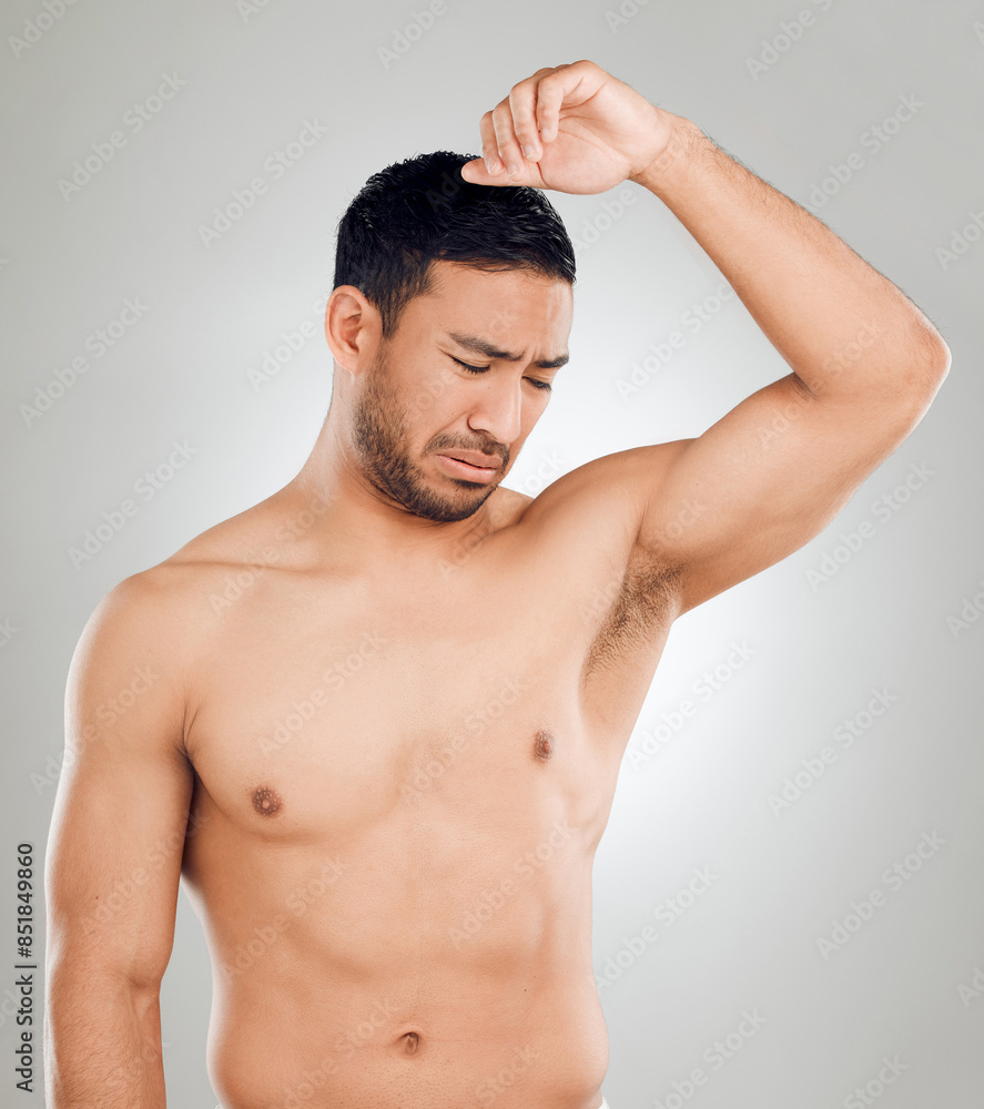 Grooming, man and underarm with bad smell in studio for routine, wellness and skincare for hygiene on white background. Male person, armpit and stink of sweat or body odor for fragrance or cologne Grooming, man and underarm with bad smell in studio for routine, wellness and skincare for hygiene on white background. Male person, armpit and stink of sweat or body odor for fragrance or cologne