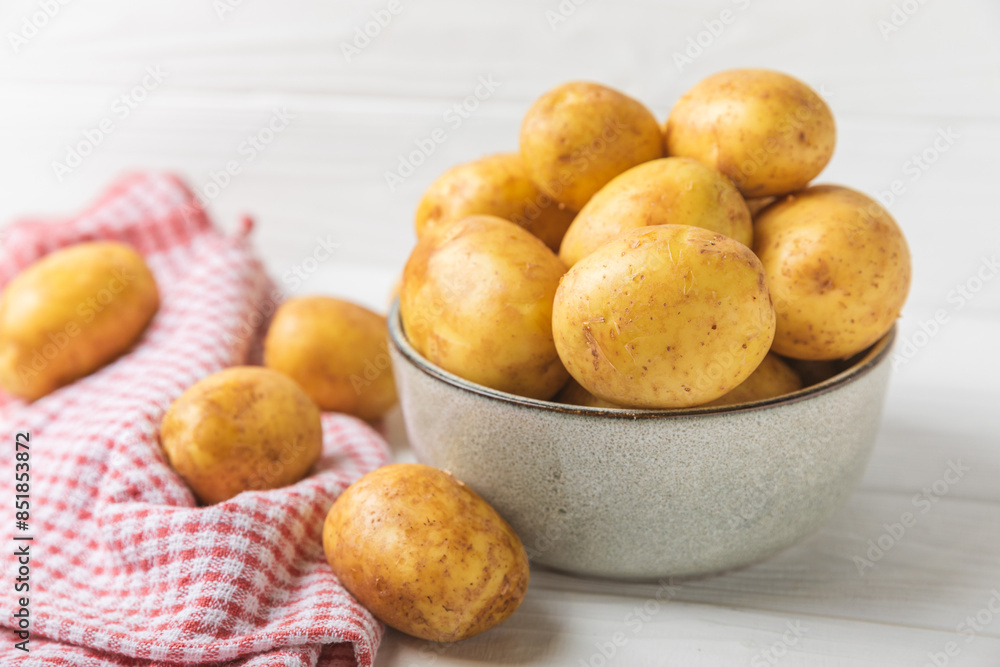 Young potatoes. Fresh potatoes on a wooden background.Harvesting collection. organic, freshly dug potatoes. Agricultural background. Vegan. Vegetables.Place for text.Copy space Young potatoes. Fresh potatoes on a wooden background.Harvesting collection. organic, freshly dug potatoes. Agricultural background. Vegan. Vegetables.Place for text.Copy space