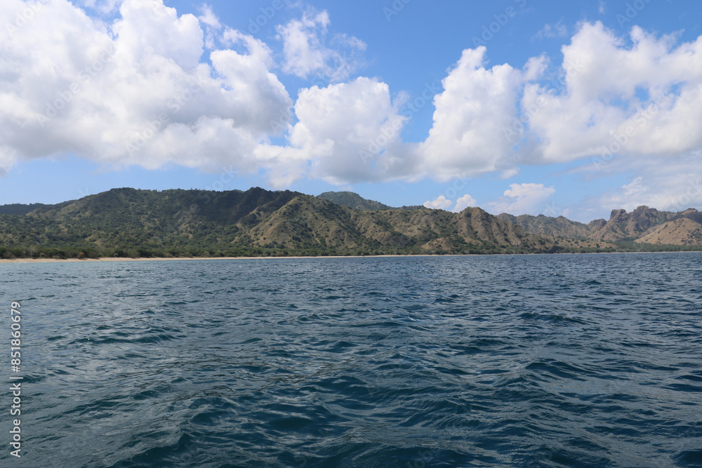 Beautiful white clouds over Komodo island mountains Beautiful white clouds over Komodo island mountains