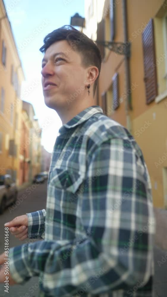 Young man wearing a plaid shirt casually strolling down a vibrant street in the city Young man wearing a plaid shirt casually strolling down a vibrant street in the city