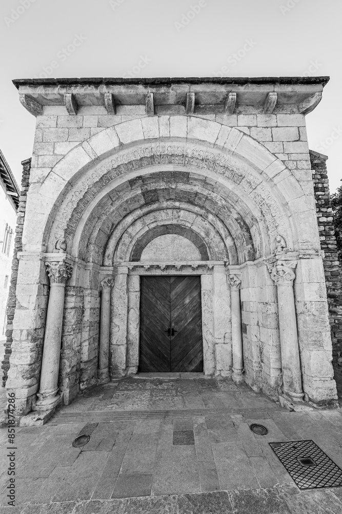 Besalú, Catalonia, Spain: Saint Julian church hospital, original 12th century facade in black and white Besalú, Catalonia, Spain: Saint Julian church hospital, original 12th century facade in black and white