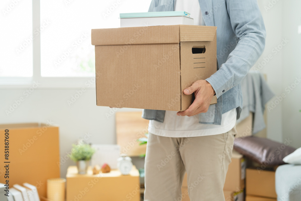 People relocation move home concept, Man carrying belongings box moving in new apartment. People relocation move home concept, Man carrying belongings box moving in new apartment.