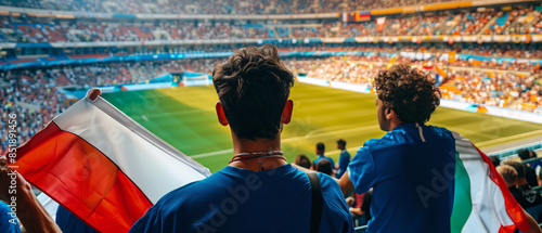 Italian football soccer fans in a stadium supporting the national team, supporting , cheering and rising italy national flag in european football league photo