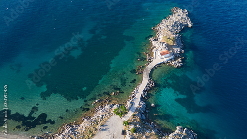 Little church of Agios Isidoros in the sea over the rocks, Chios island, Greece. photo