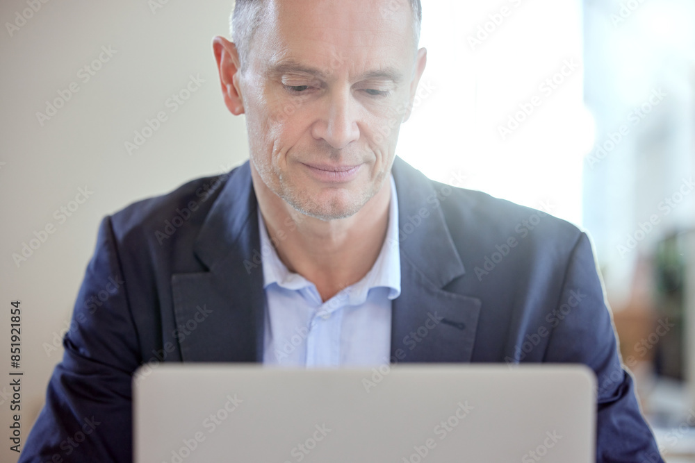 Laptop, management and mature business man in office for corporate planning or online research. Administration, computer and email with serious company manager in professional workplace for report Laptop, management and mature business man in office for corporate planning or online research. Administration, computer and email with serious company manager in professional workplace for report