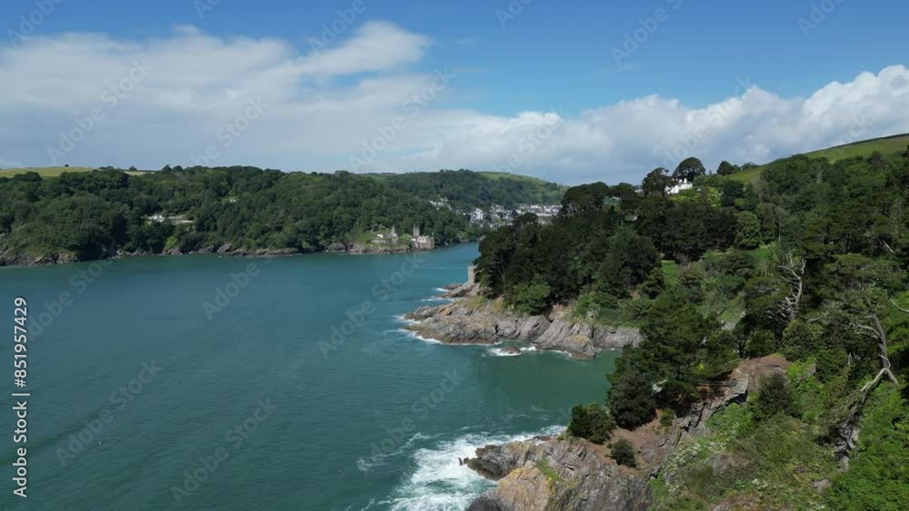 River Dart, South Devon, England: DRONE VIEWS: Rugged coastline at the mouth of the River Dart with the town of Dartmouth in the distance. Dartmouth is a popular UK holiday destination (4).