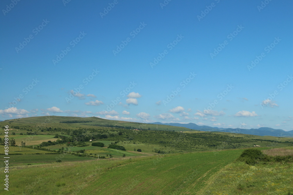 A landscape with green hills and blue sky A landscape with green hills and blue sky