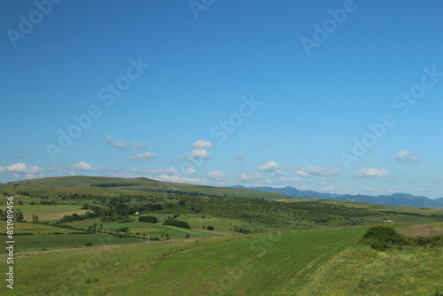 A landscape with green hills and blue sky